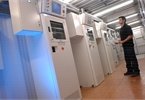 Male inspecting multiple automated gas cabinets with hmi's.